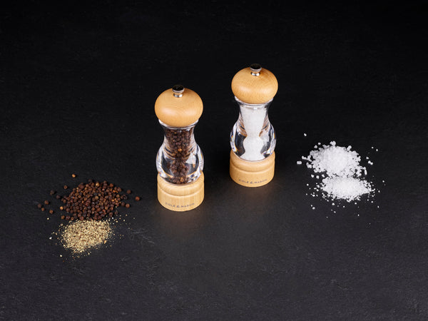 salt and pepper mills on a dark background