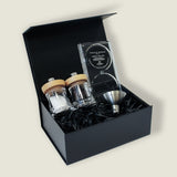 The Cole & Mason Holborn Mill Christmas Gift Hamper includes two clear glass spice jars with wooden lids, a metal funnel, and an acrylic fill tray in a black box—perfect for gifting or pairing with your Holborn Salt and Pepper Mills.