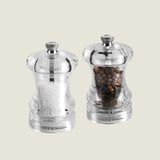 #85mm#pepper
The Cole & Mason Acrylic Capstan Salt & Pepper Mills, shown side by side on a white background, feature durable grinding mechanisms. One is filled with white salt crystals, the other with whole black peppercorns.