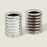 The Cole & Mason Beehive Shakers Set features two ribbed acrylic dispensers with shiny silver tops, filled with white salt and black pepper, displayed side by side on a light background for lasting style.