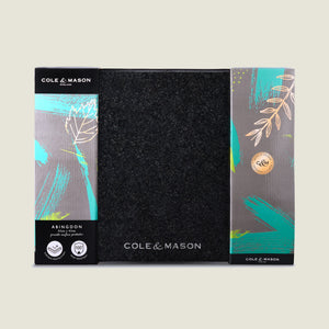 Cole & Mason Black Granite Surface Protector in packaging, featuring heat-resistant black stone in a box with green, gold, and blue abstract patterns and the Cole & Mason logo on the front—ideal for stylish kitchen décor.