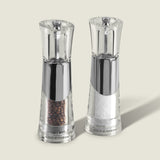 The Cole & Mason Bobbi Salt & Pepper Mill Set features two clear, modern mills with silver accents, adjustable grinders, and durable mechanisms. Each is prefilled with black peppercorns or coarse sea salt and labeled Cole & Mason at the base.