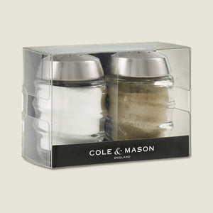 Upgrade your kitchen with the Cole & Mason Bray Glass Shakers Set, featuring elegant glass shakers with stainless steel tops. Includes one salt and one pepper shaker, attractively packaged in a clear box marked Cole & Mason.