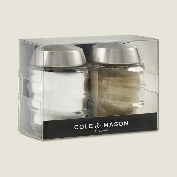 Upgrade your kitchen with the Cole & Mason Bray Glass Shakers Set, featuring elegant glass shakers with stainless steel tops. Includes one salt and one pepper shaker, attractively packaged in a clear box marked Cole & Mason.