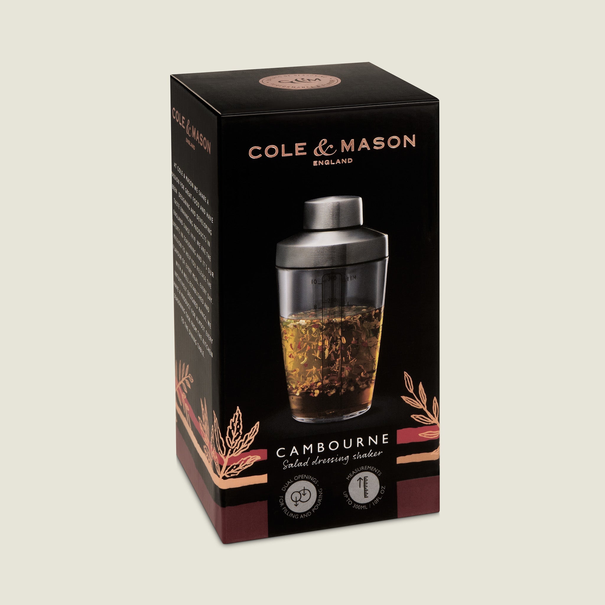 Cole & Mason Cambourne Salad Dressing Shaker, ideal for making homemade dressings. The black packaging has gold, white, and copper accents with an image of the filled shaker on the front.