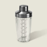 The Cole & Mason Cambourne Salad Dressing Shaker features clear glass with a stainless steel lid and measurement lines in ounces, milliliters, and cups—ideal for mixing cocktails, vinaigrettes, or dressings on any surface.