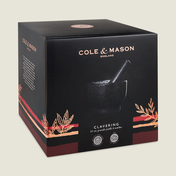 A black box with Cole & Mason branding displays the Clavering Pestle & Mortar, a 20 cm granite kitchen tool perfect for home chefs. Decorative wheat graphics and product details appear on the front.