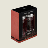The Cole & Mason Clovelly Salt & Pepper Mill Set features a modern design with stainless steel tops, adjustable grinds, and is showcased in black and red Clovelly packaging with a clear window.