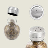 The Cole & Mason Darlington Shakers Set features a round glass and stainless steel pepper shaker, shown with lid on, off, and highlighting its holes—offering precise seasoning control for any meal.