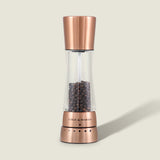 A Cole & Mason Derwent Copper Salt & Pepper Mill, filled with black peppercorns and featuring precision grind technology, stands upright on a light beige background.