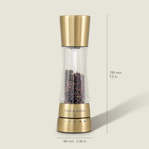 A Cole & Mason Derwent Gold salt & pepper mill stands upright, filled with black peppercorns. Its gold-tone stainless steel body measures 190 mm tall and 60 mm wide, and features advanced grinding technology.