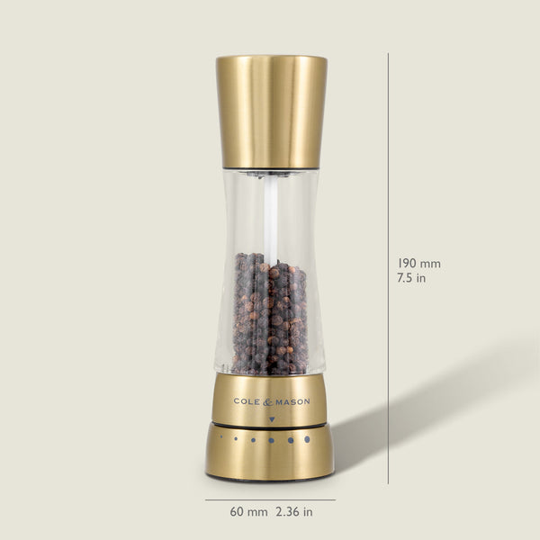 A Cole & Mason Derwent Gold salt & pepper mill stands upright, filled with black peppercorns. Its gold-tone stainless steel body measures 190 mm tall and 60 mm wide, and features advanced grinding technology.