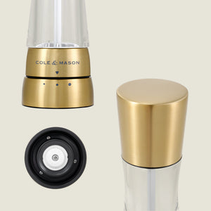 The Cole & Mason Derwent Gold Salt & Pepper Mills are shown from the front, top, and bottom, highlighting their gold-tone stainless steel design and advanced grinding technology.