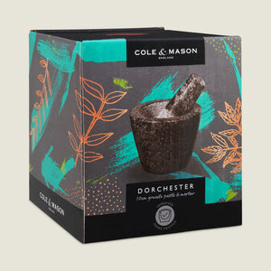 A box for the Cole & Mason Dorchester Granite Pestle & Mortar, showing the product image with colorful leaf patterns on a dark background—ideal for grinding herbs and making fresh spice blends.