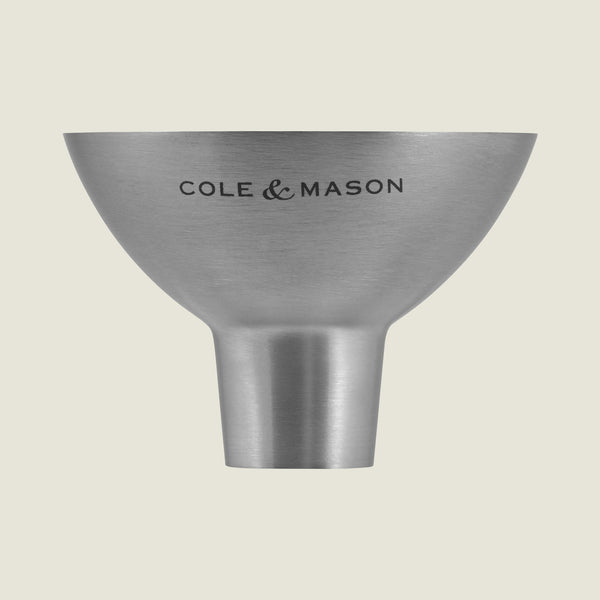 The Cole & Mason Dover Stainless Steel Funnel is an easy-to-clean kitchen essential, designed for effortless pouring and featuring signature Cole & Mason branding against a light, pale background.