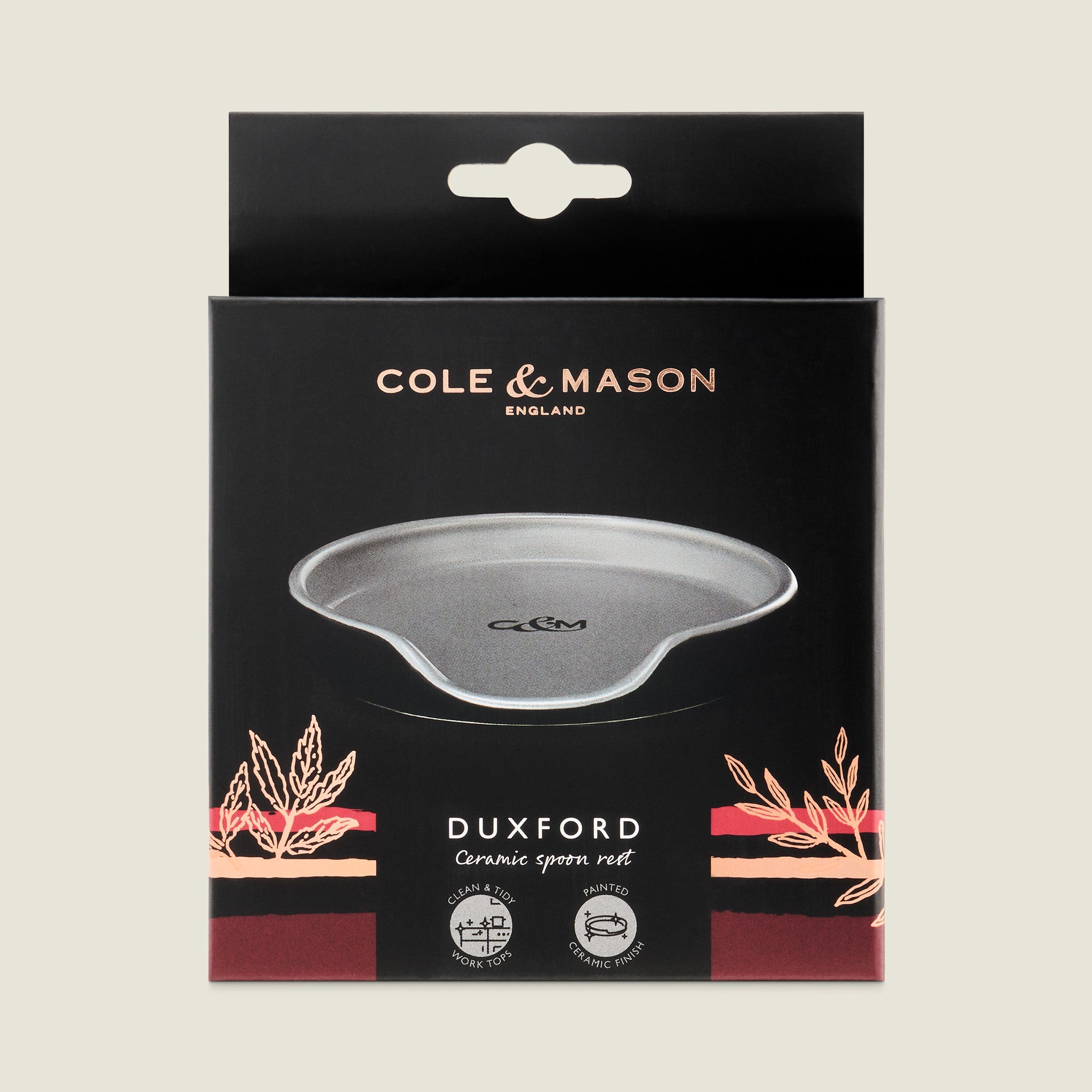 The Cole & Mason Duxford Ceramic Spoon Rest comes in a sleek black box, featuring a grey rest with gold and pink accents—an elegant touch for your kitchen.