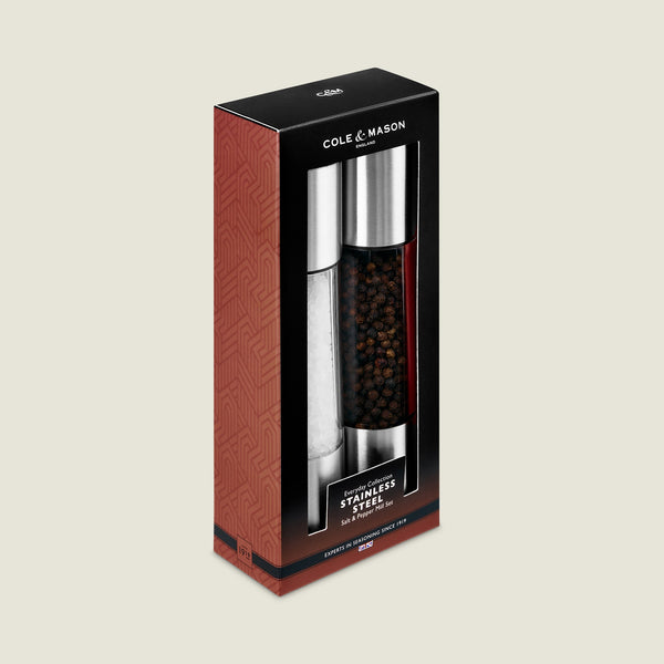 Cole & Mason Everyday Stainless Steel Salt & Pepper Mill Set in black and red packaging with white text comes in a rectangular box with a transparent window, showing the ergonomic, filled grinders with adjustable coarseness.