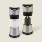 #salt&pepperset
Two Cole & Mason Horsham Salt & Pepper Mills are shown side by side; the left holds coarse salt, the right, whole peppercorns. Both have clear midsections to display contents and offer high-performance grinding with adjustable settings.
