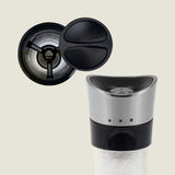 #salt
A close-up of Cole & Mason’s Horsham Salt & Pepper Mills shows a stainless steel top, black accents, and visible salt crystals, with the open lid from above revealing its high-performance grinding mechanism.