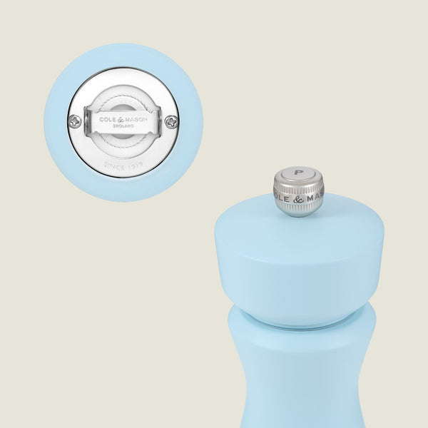 A Kenton Blue Salt & Pepper Mill by Cole & Mason is shown, featuring a close-up of the brushed metal top with a P knob, emphasizing its refillable design and ceramic mechanism.