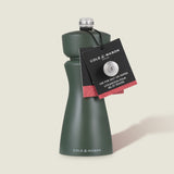 A dark green Cole & Mason Kenton Salt & Pepper Mill in Rosemary with a ceramic mechanism and silver top, plus a black tag for salt or pepper, is shown on a light background.