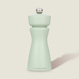 The Cole & Mason Kenton Sage Salt & Pepper Mill features a light green finish, a silver top knob, and a durable ceramic mechanism. It stands upright against a plain, off-white background.