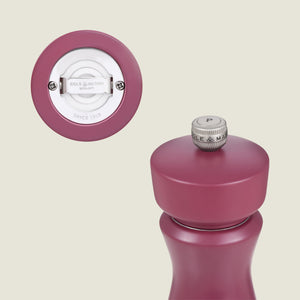 A close-up of the Kenton Sichuan Pepper Red Salt & Pepper Mill by Cole & Mason, featuring an interchangeable knob marked P and a durable ceramic grinding mechanism—perfect as a Sichuan pepper mill.