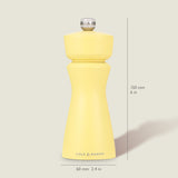 The Cole & Mason Kenton Salt & Pepper Mill in Turmeric Yellow stands upright on a light background, measuring 150 mm tall and 60 mm wide, featuring a silver top knob, ceramic mechanism, and the brand name on its base.