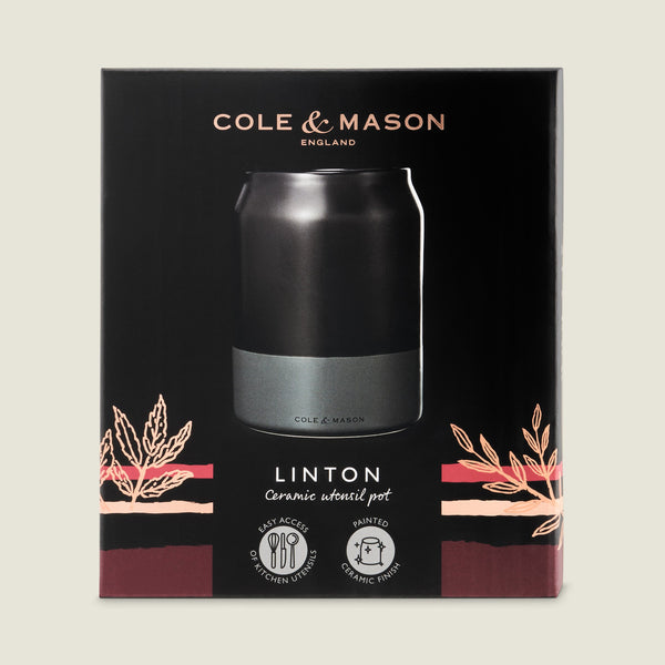 The Cole & Mason Linton Ceramic Utensil Pot features a sleek black and gray design with decorative leaf illustrations, perfect for organizing kitchen utensils. Supplied in a branded box, its ceramic lining ensures easy access and stylish storage.