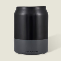 The Cole & Mason Linton Ceramic Utensil Pot, a matte black and gray soda can-shaped container with branding near the base, is ideal for storing cooking utensils and shown against a light beige background.