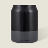 The Cole & Mason Linton Ceramic Utensil Pot, a matte black and gray soda can-shaped container with branding near the base, is ideal for storing cooking utensils and shown against a light beige background.