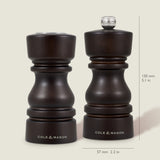 The Cole & Mason London Chocolate Wood Salt Shaker & Pepper Mill Set features two dark wooden mills, each 130 mm tall and 57 mm wide, with a premium grinding mechanism for enhanced performance.