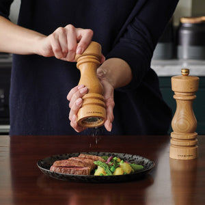 #180mm
Cole & Mason beech wood pepper mill in use over plated steak on a dark wooden kitchen counter