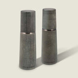 Two Marlow Grey Beech Salt & Pepper Mills by Cole & Mason UK, featuring a smooth tapered shape and wood grain, stand upright on a light background with an adjustable grinding mechanism for custom seasoning.