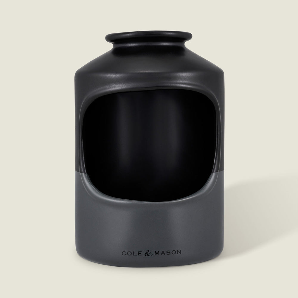 The Cole & Mason Strethall Ceramic Salt Pig features a matte black and grey finish, an open front for easy seasoning control, and the brand name printed near the base, shown against a light background.