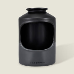 The Cole & Mason Strethall Ceramic Salt Pig features a matte black and grey finish, an open front for easy seasoning control, and the brand name printed near the base, shown against a light background.