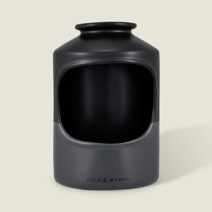The Cole & Mason Strethall Ceramic Salt Pig features a matte black and grey finish, an open front for easy seasoning control, and the brand name printed near the base, shown against a light background.
