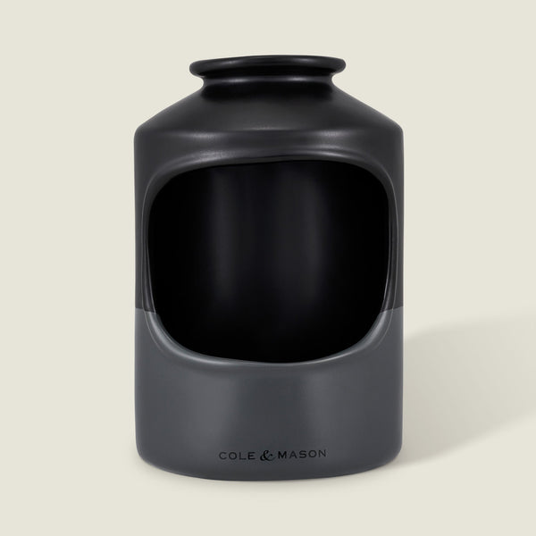 The Cole & Mason Strethall Ceramic Salt Pig features a matte black and grey finish, an open front for easy seasoning control, and the brand name printed near the base, shown against a light background.